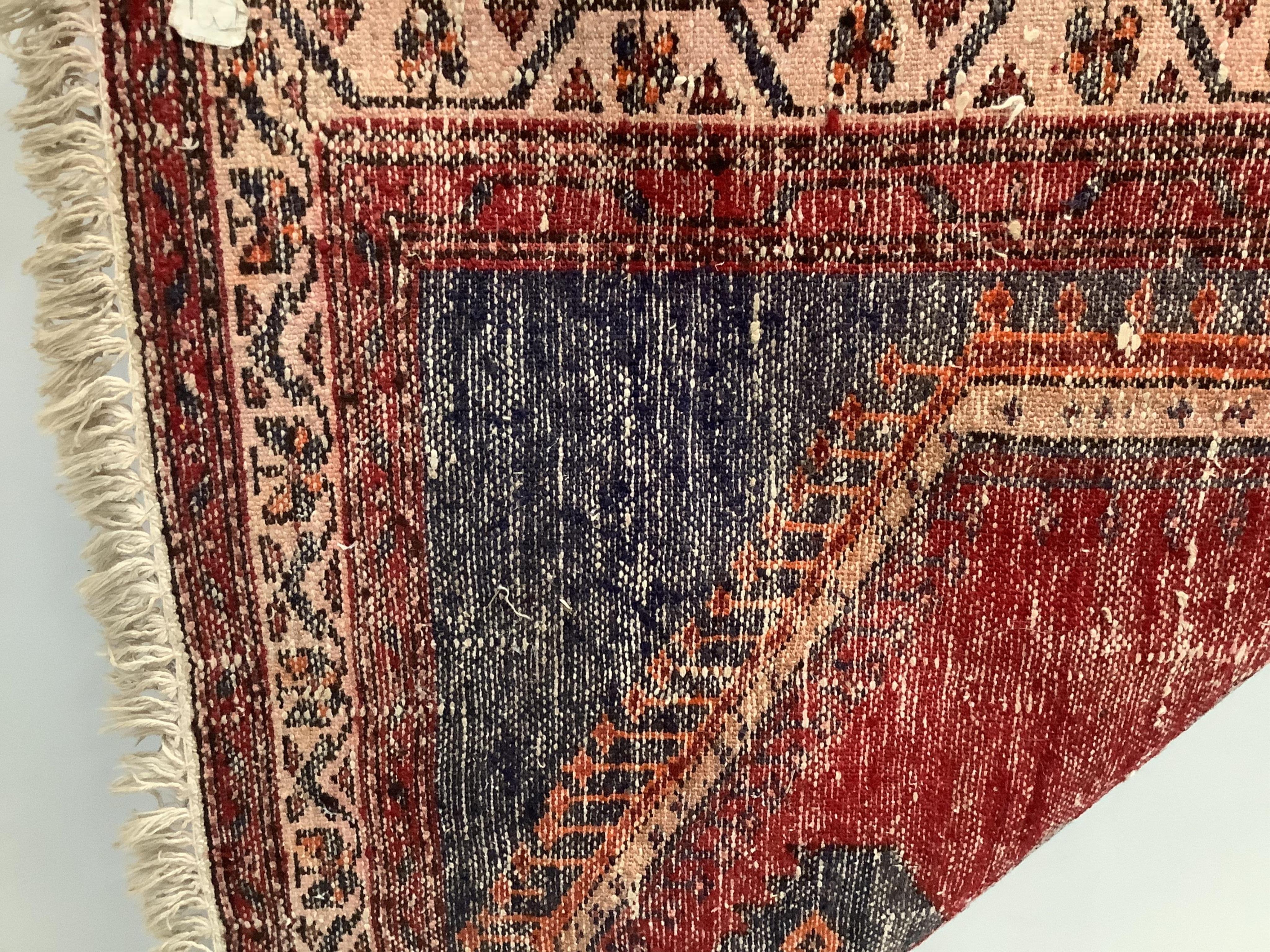 A Caucasian style red ground rug, 200 x 110cm. Condition - fair